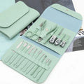 Mint green manicure set with tools in a case on a white background