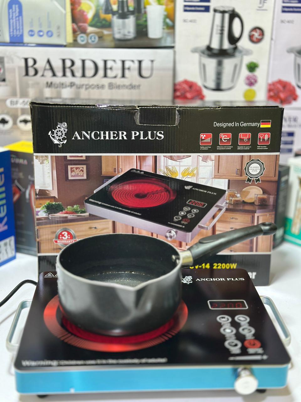 Portable induction cooktop with pot on a white surface, featuring Anchor Plus branding.