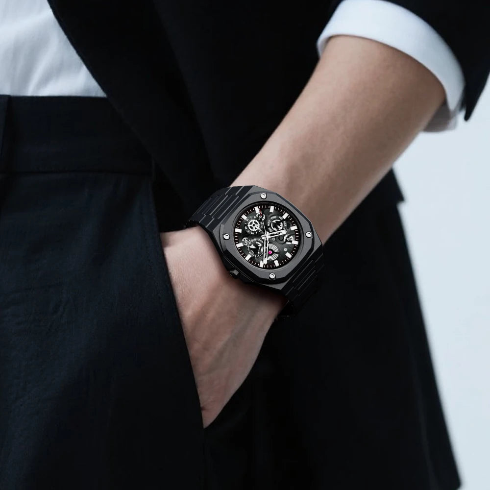 Black watch on a person's wrist with a blurred background