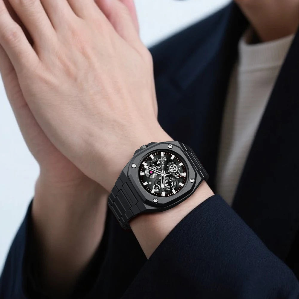 Black wristwatch on a person's wrist with a blurred background
