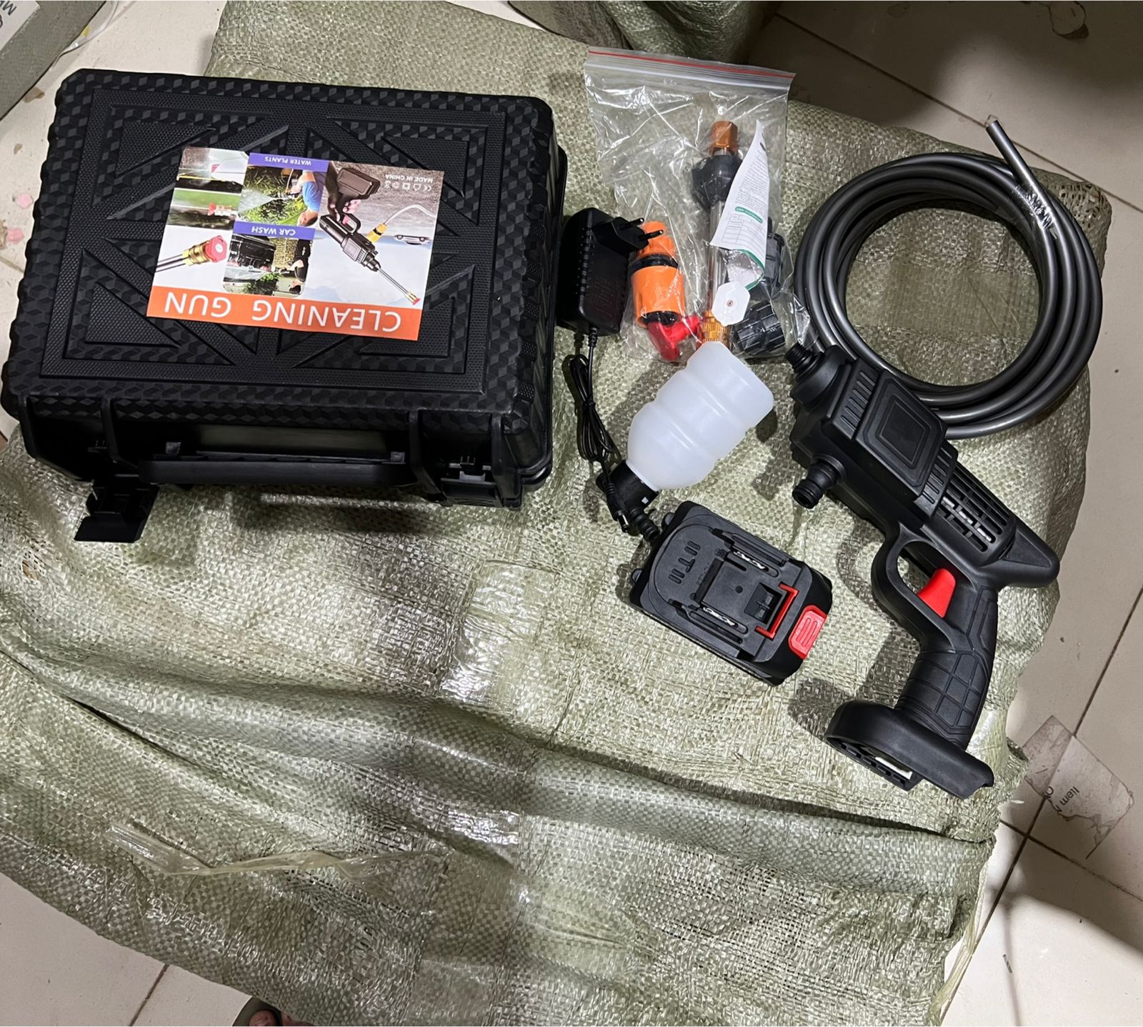 Cleaning gun set with case and accessories on a textured surface