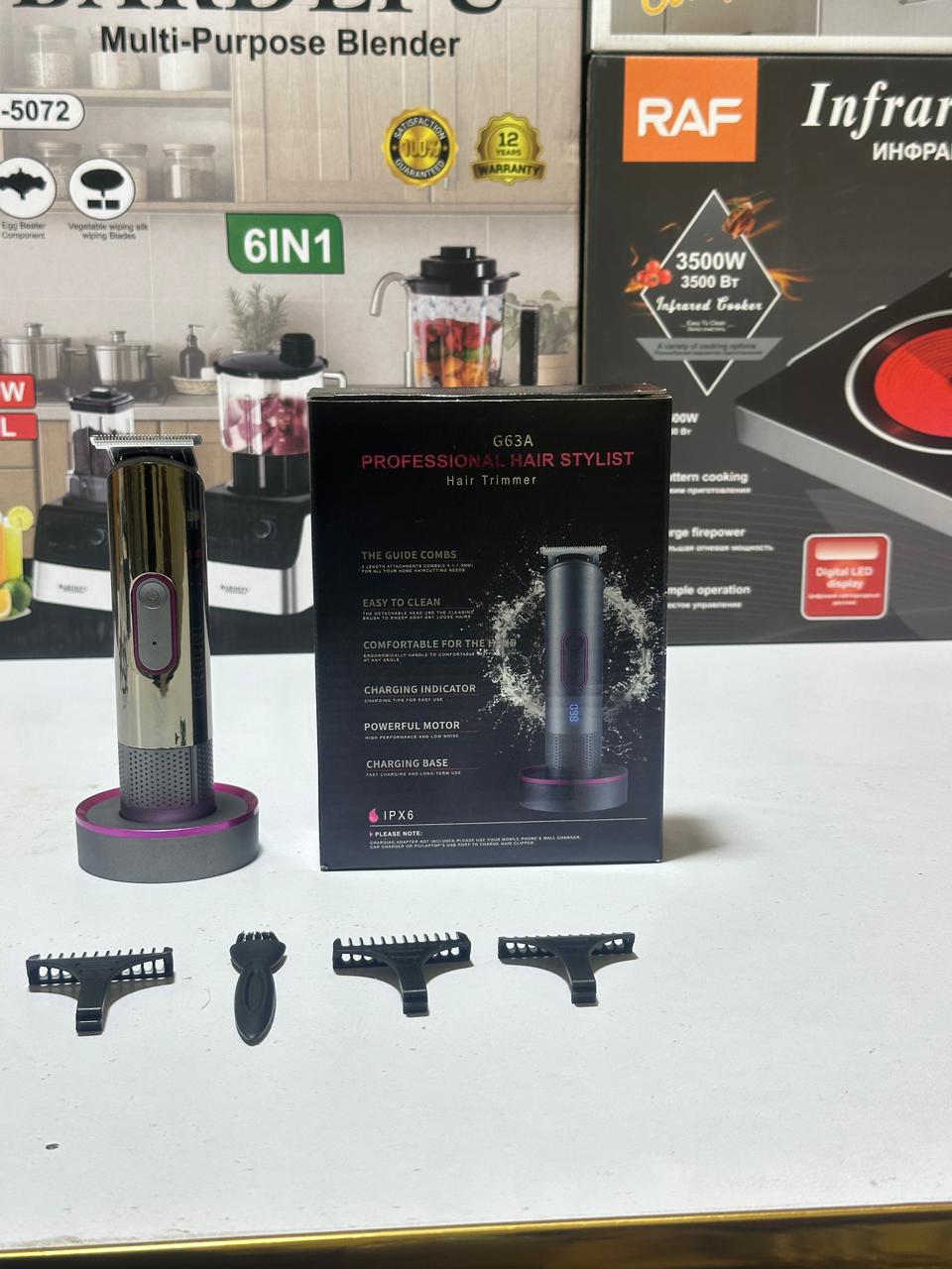 Hair styling tool with attachments and packaging on a white surface