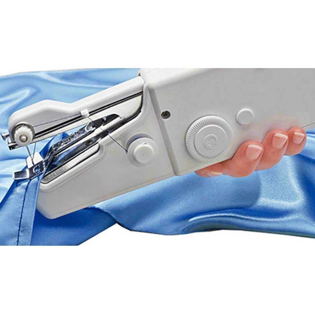 Handheld sewing machine on a blue fabric background