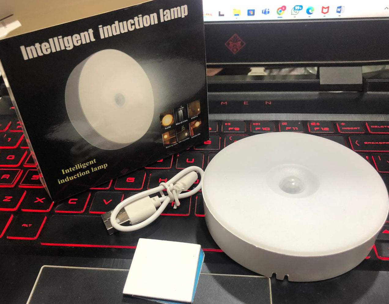 Intelligent induction lamp with packaging on a laptop keyboard
