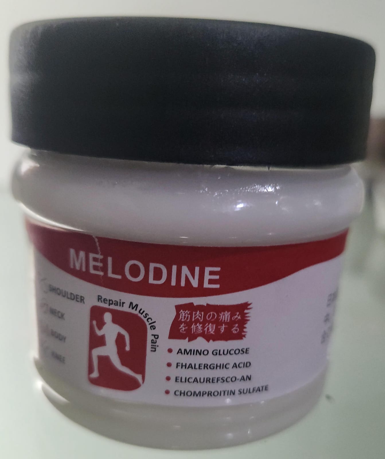 Jar of Melodine with a black lid on a white background