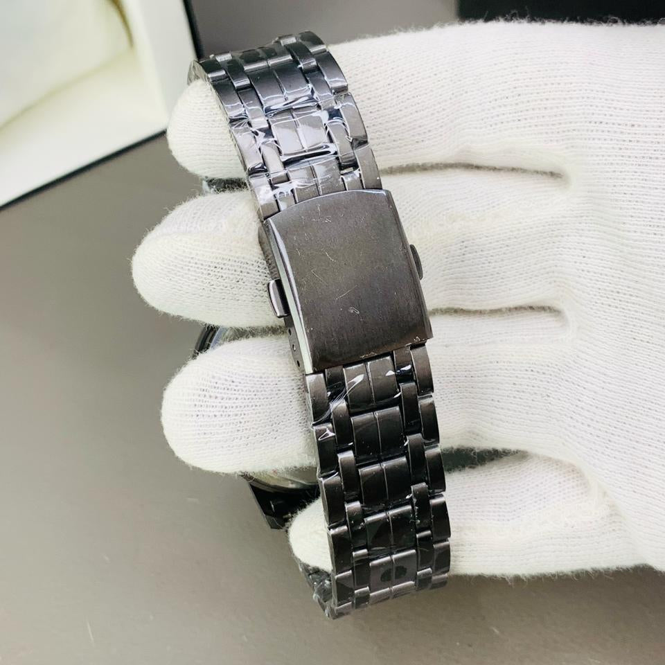 Metallic watch band on a white glove