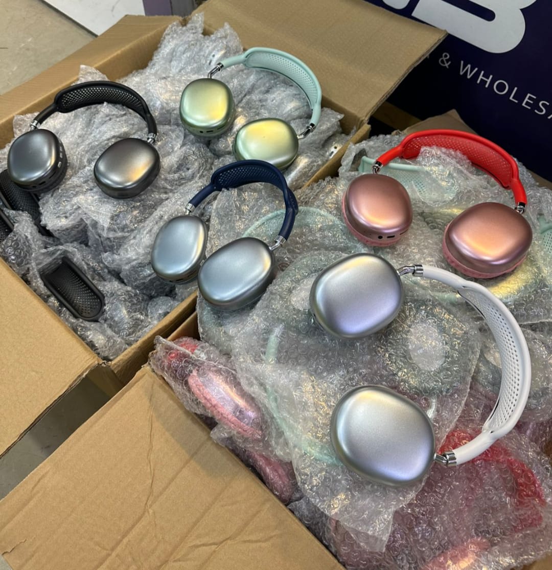 Multiple pairs of headphones in various colors and designs on a cardboard surface.