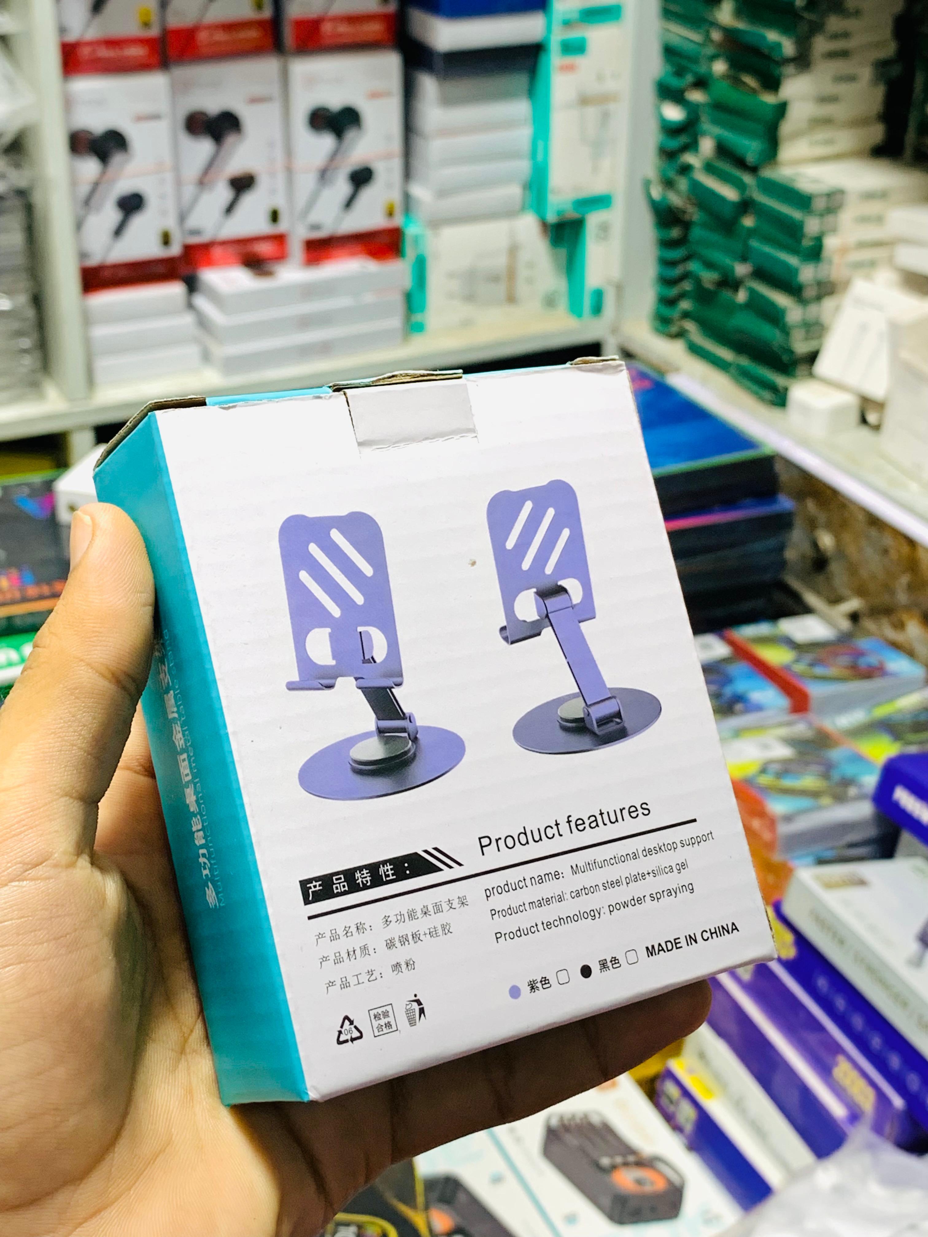 Product packaging held by a hand in a store setting