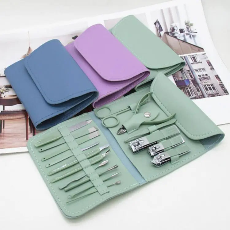 Set of manicure tools in a green case on a white surface with magazines in the background.