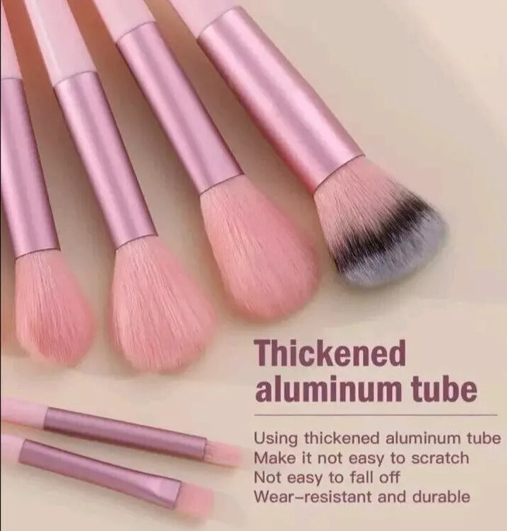 Set of pink makeup brushes with a beige background and text about thickened aluminum tubes.