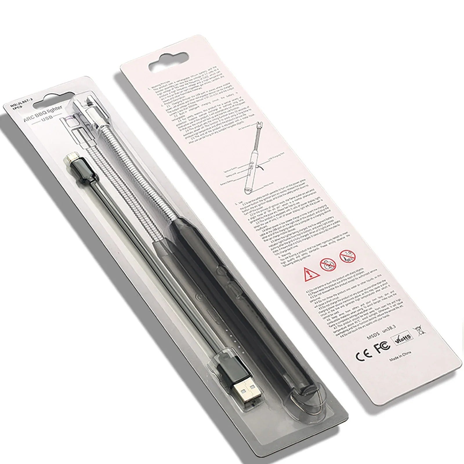 Black electronic device with USB cable in clear packaging on a white background