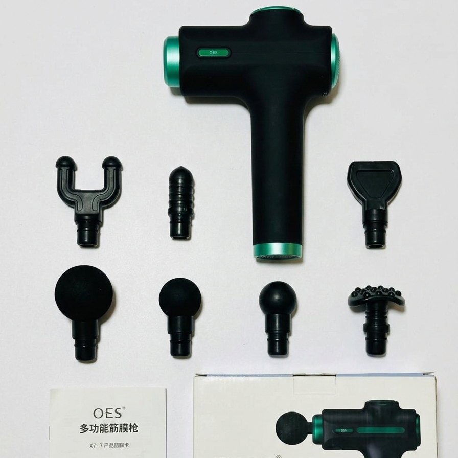 Black and green massage gun with multiple attachments on a white background